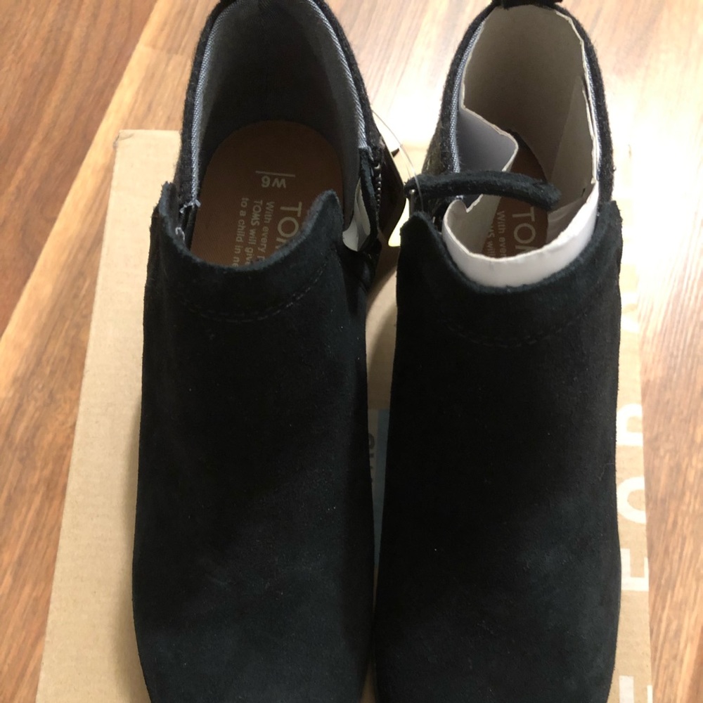 Tom’s black booties